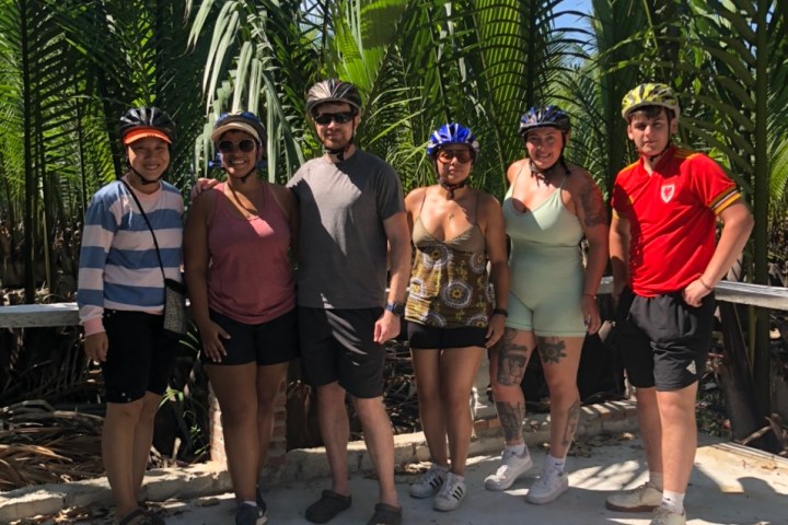 a group of people standing next to a tree