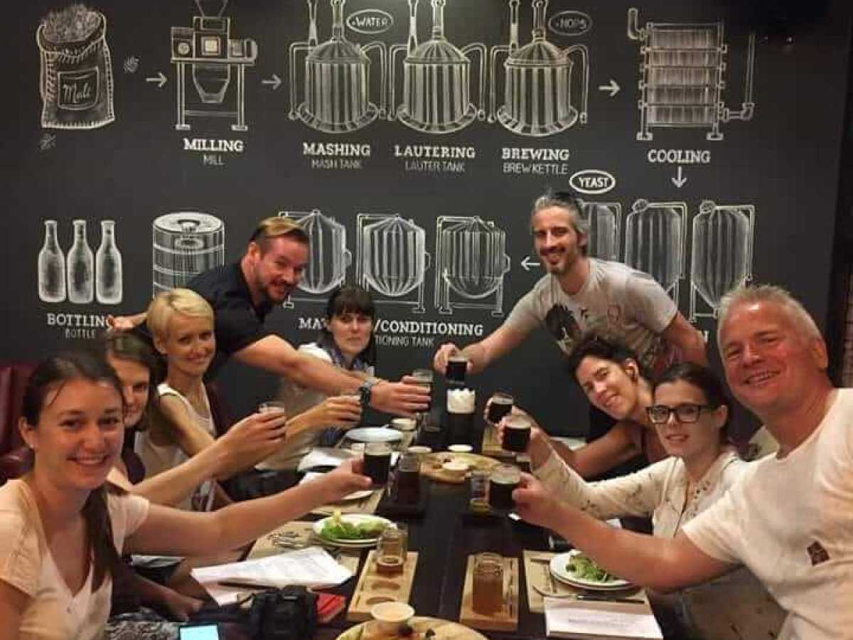 a group of people sitting at a table posing for the camera