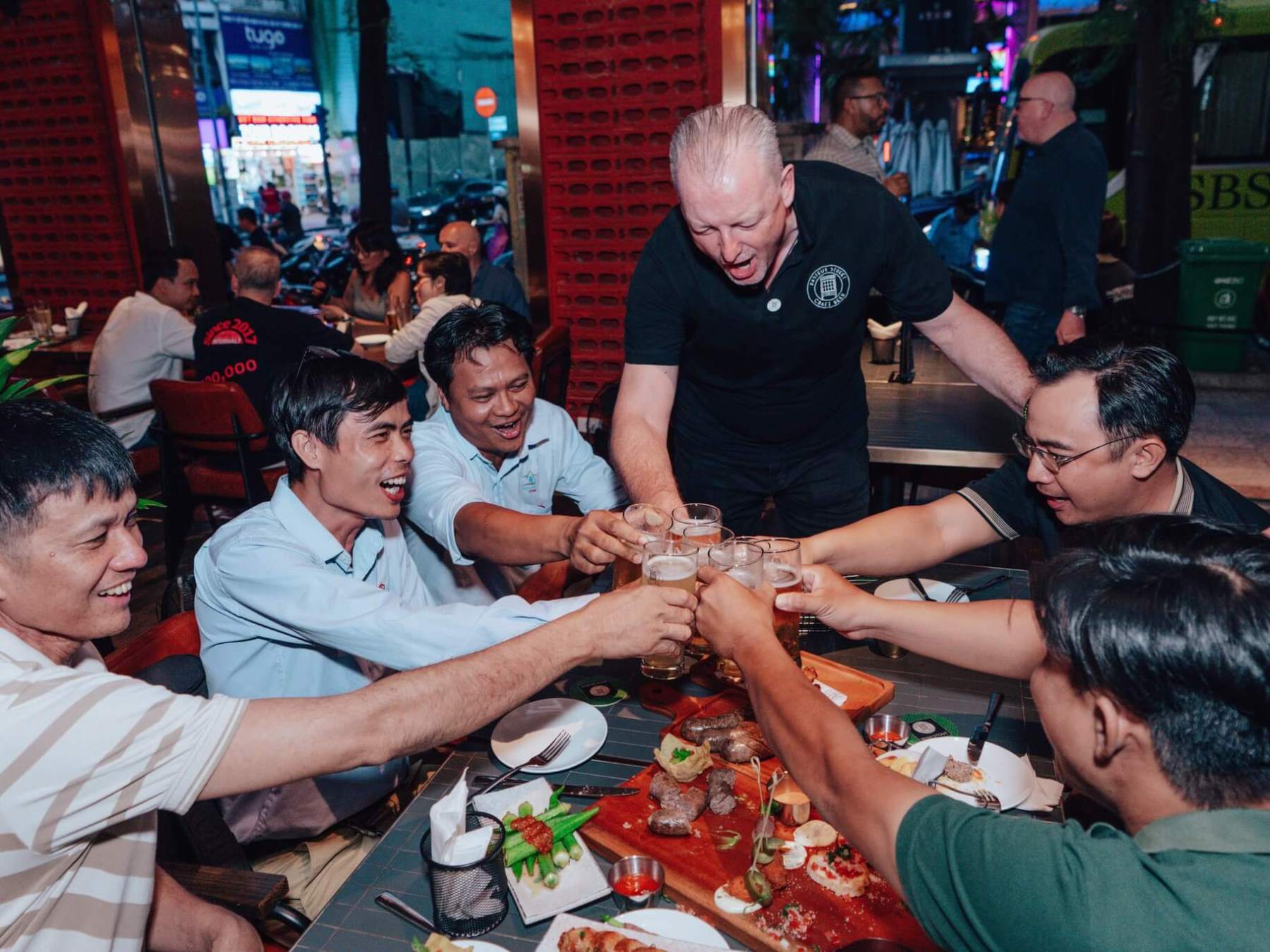 a group of people sitting at a table eating food