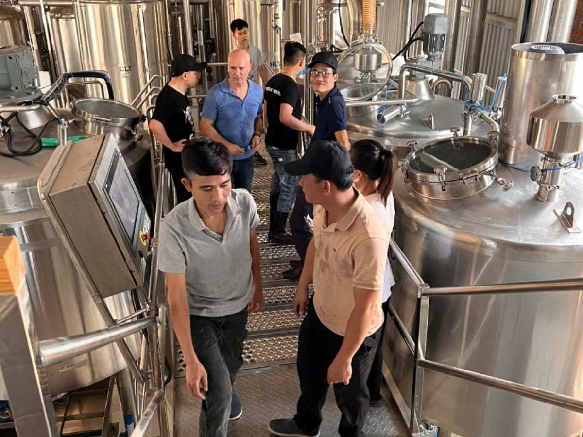 a group of people standing in a kitchen
