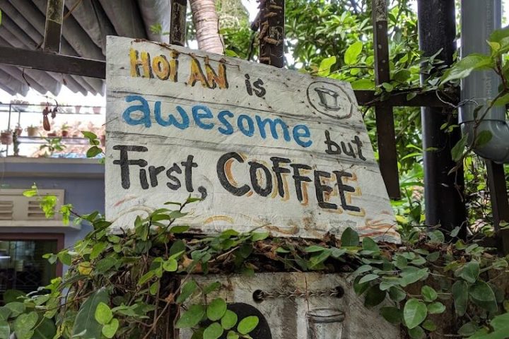 a sign hanging off the side of a building