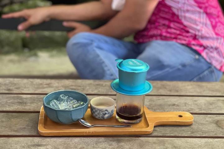 a person sitting at a table with some shoes