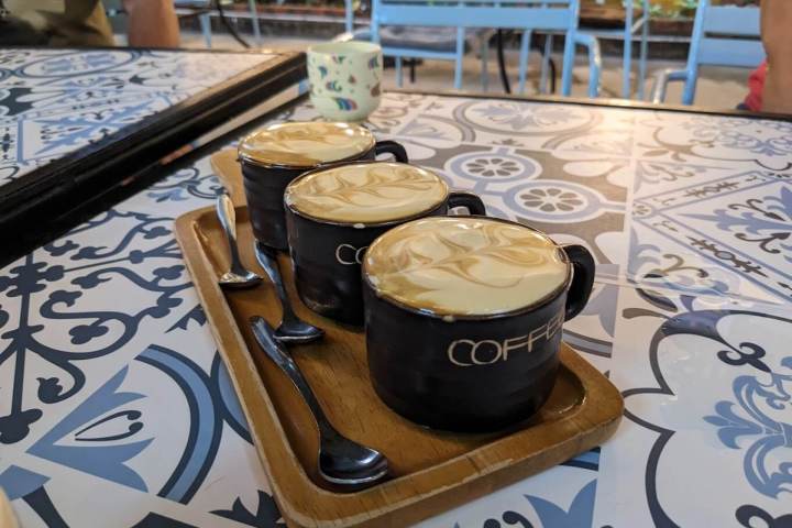 a cake sitting on top of a table next to a cup of coffee