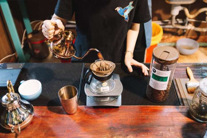 a person pouring coffee