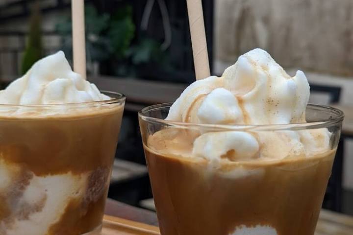 a cup of coffee and a glass of beer on a table