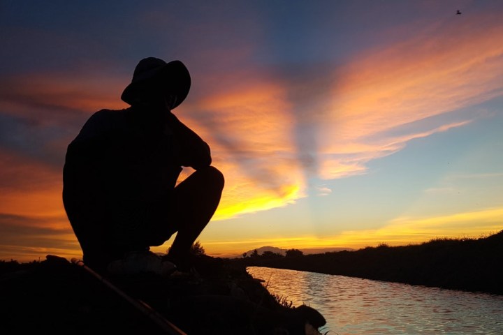 a person with a sunset in the background