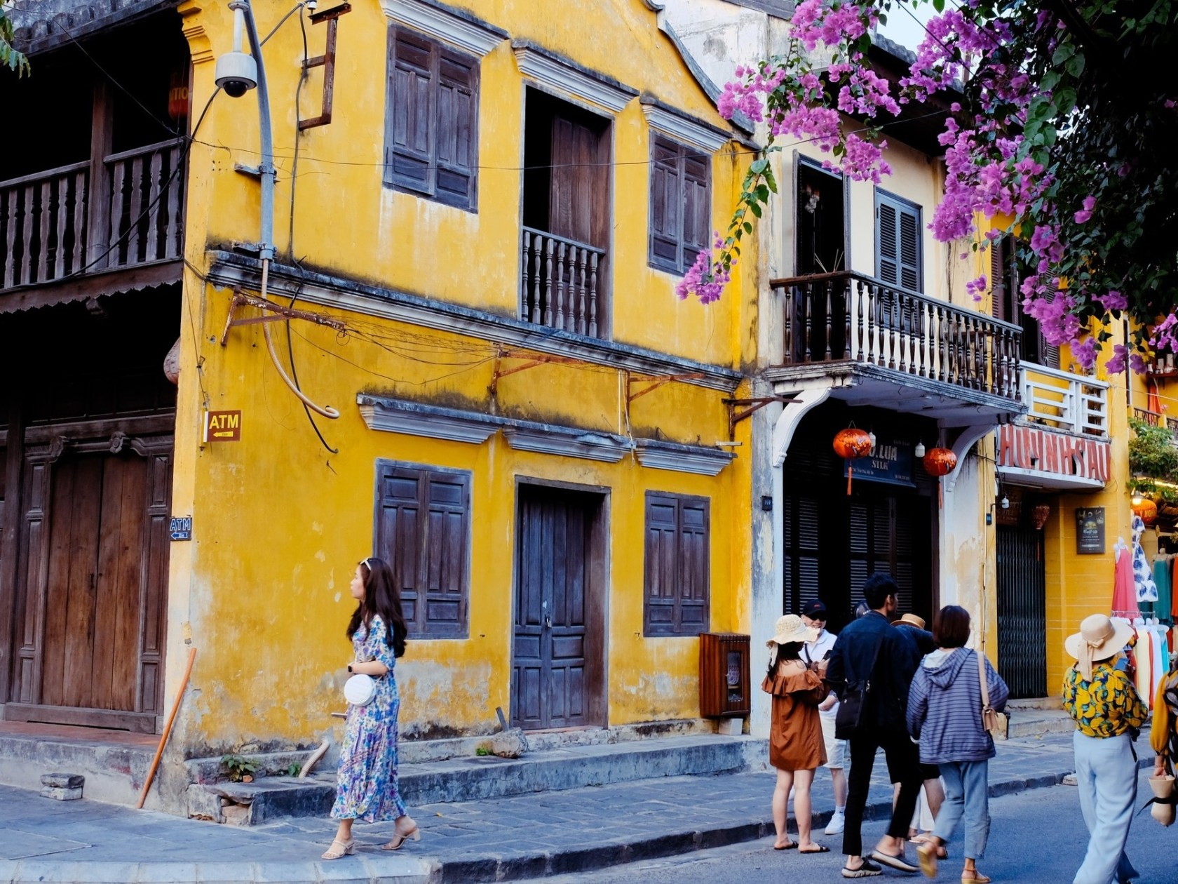 a person walking down a street in front of a building
