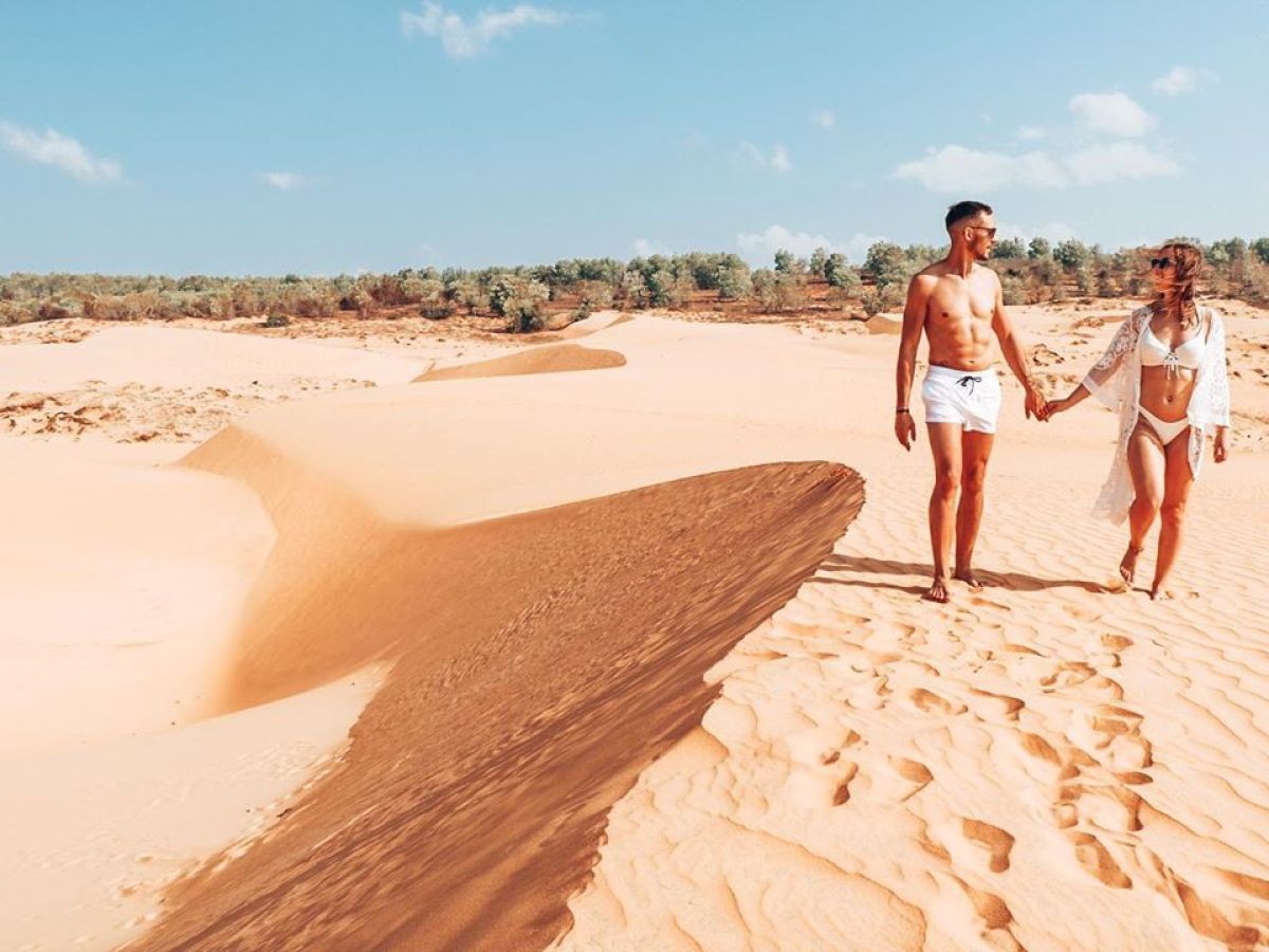 a man standing on top of a sandy beach