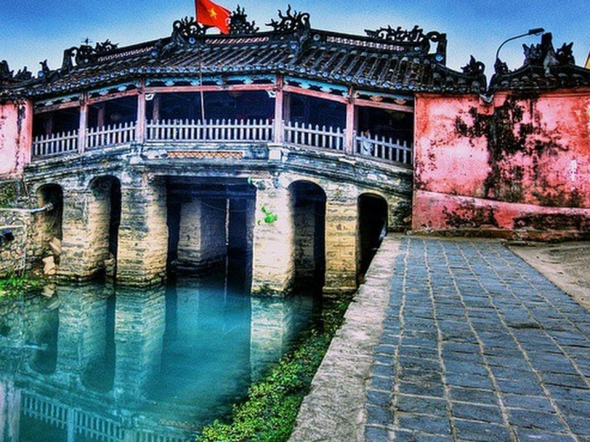 a bridge over a body of water in front of a building
