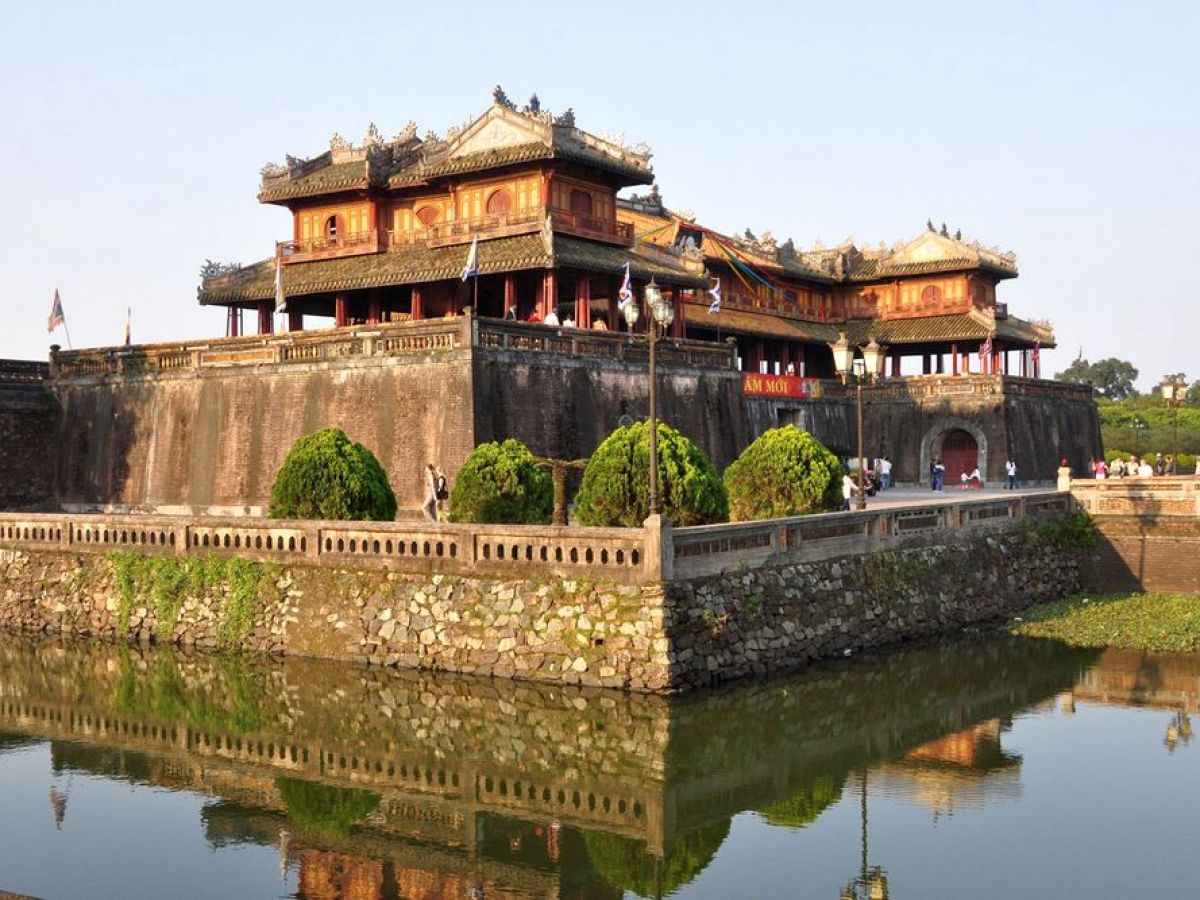 a train crossing Hue over a body of water