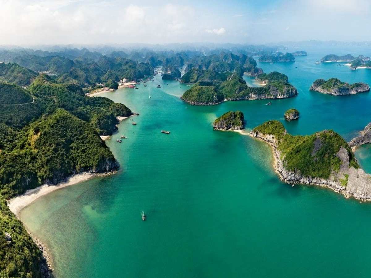 a small boat in a body of water with a mountain in the background