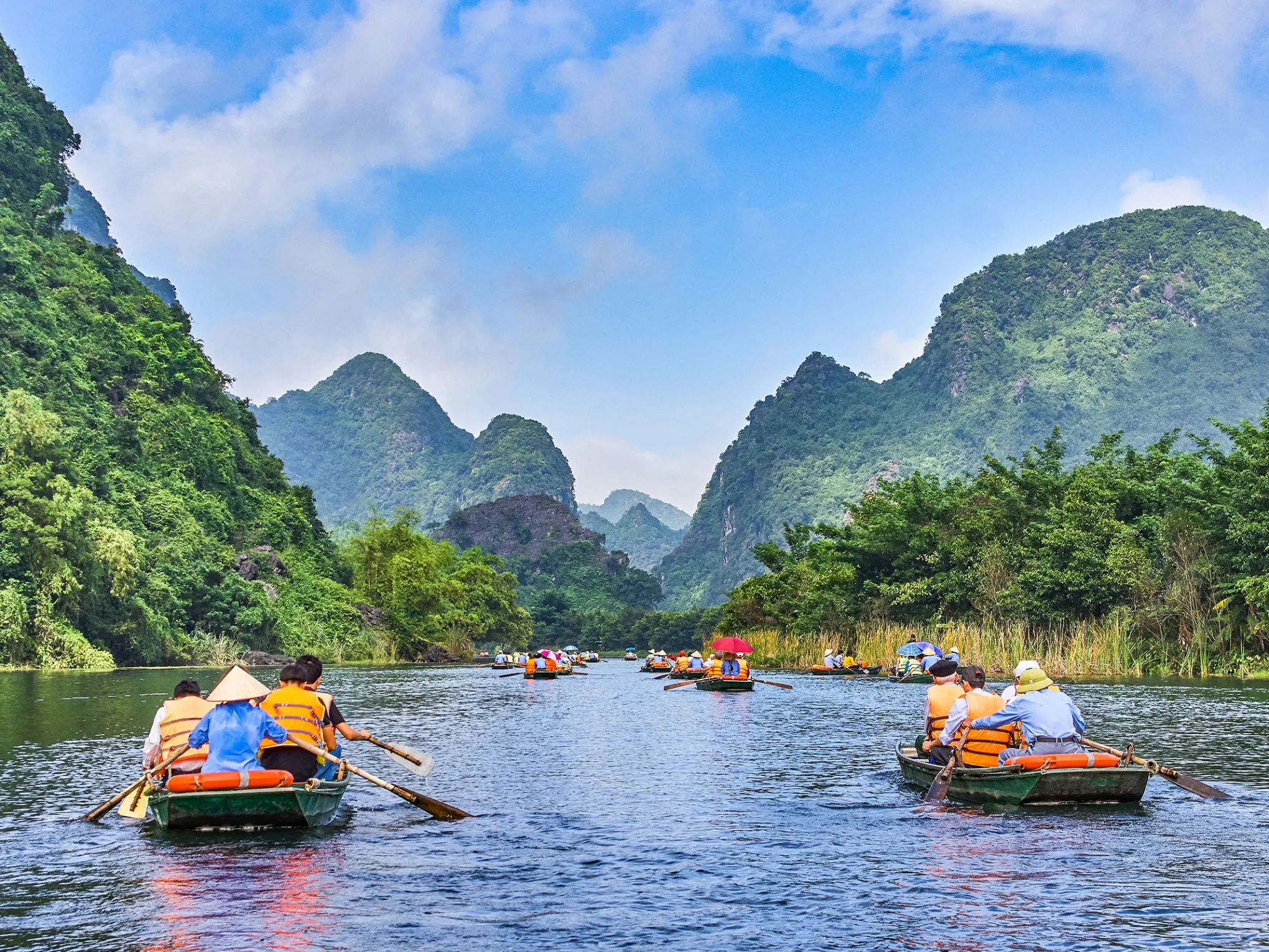 a small boat in a body of water with Yulong River in the background