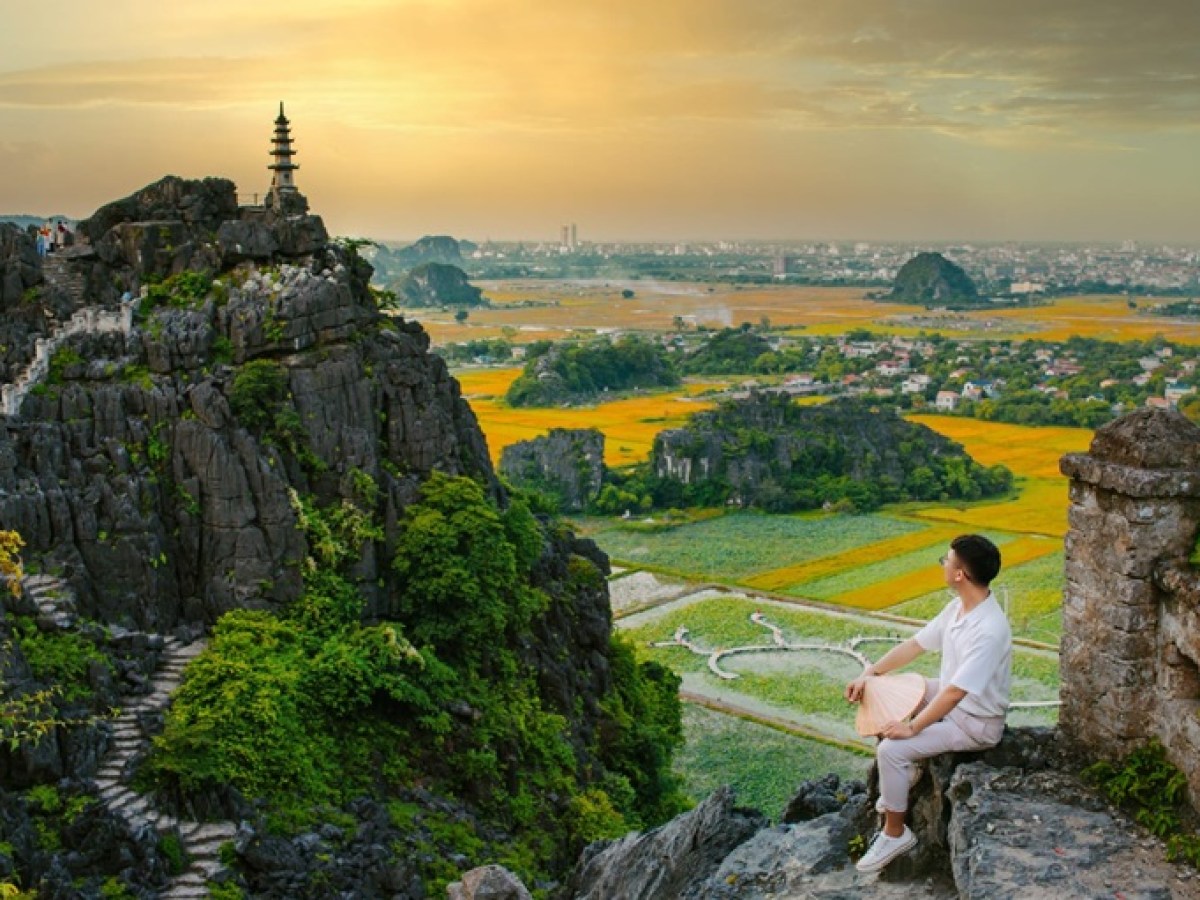 a man standing next to a waterfall