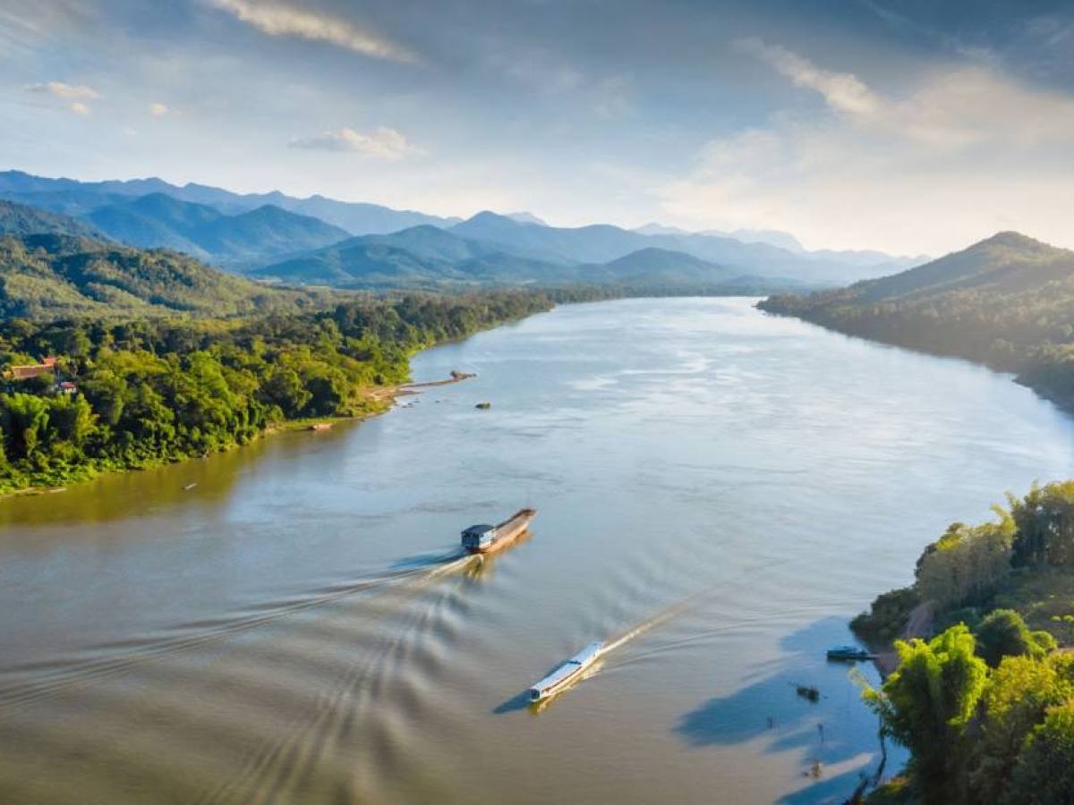 a body of water with a mountain in the background