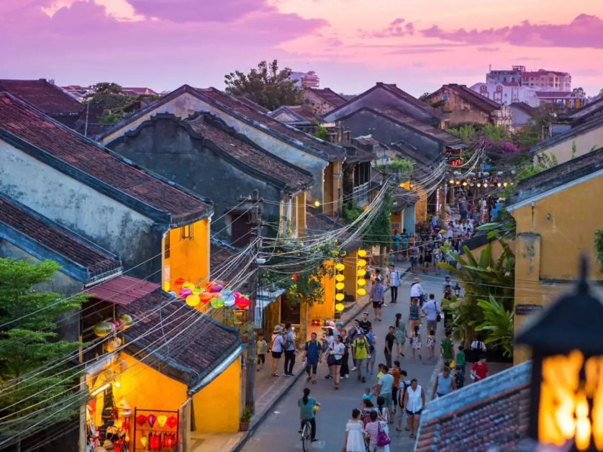 a group of people walking down a street next to a building