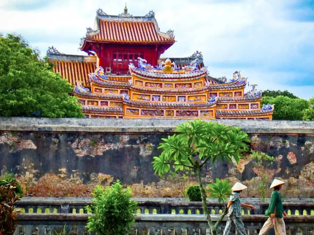 a group of people sitting on a bench in front of a building