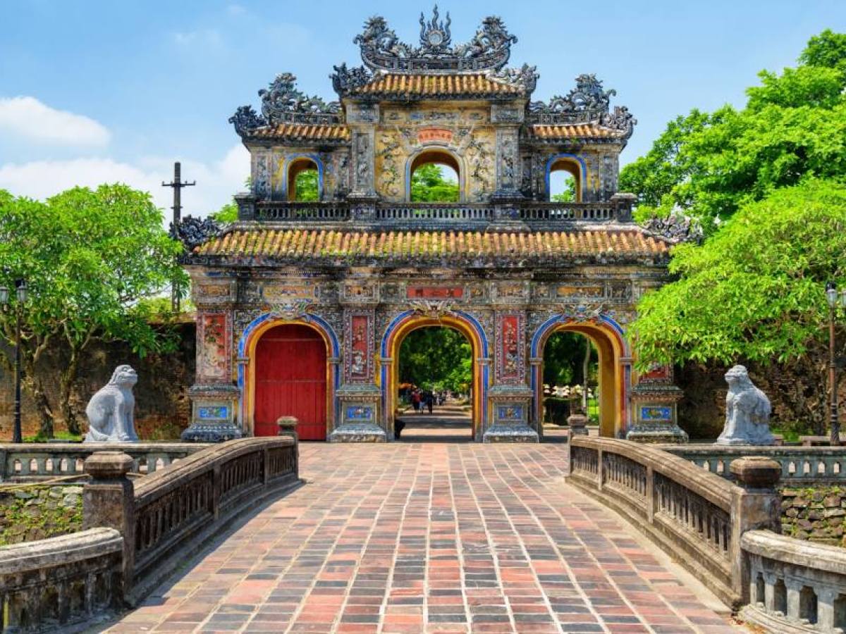 a person sitting on a bench in front of a building