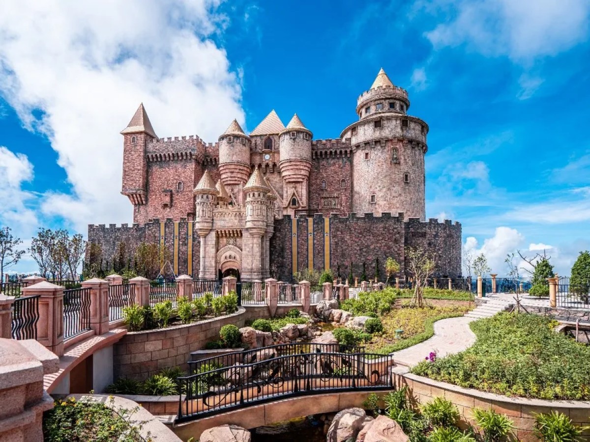 a stone castle next to a brick building