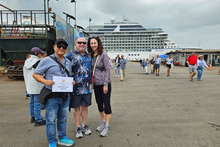 a group of people standing in a parking lot