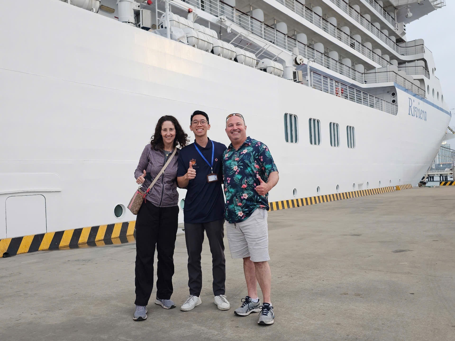 a group of people standing next to a ship