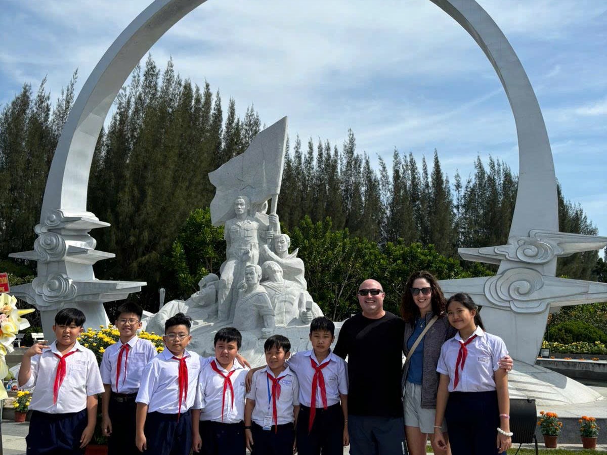 a group of people standing in front of a crowd posing for the camera