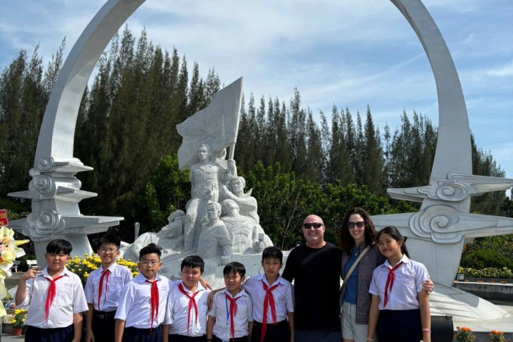 a group of people standing in front of a crowd posing for the camera