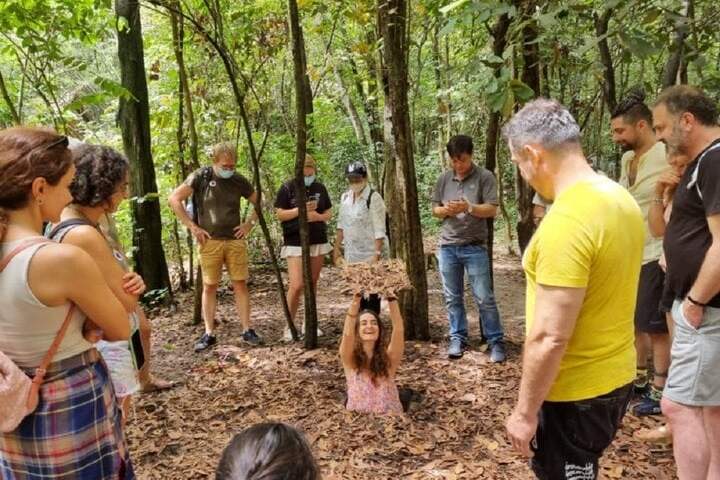 a group of people standing next to a tree