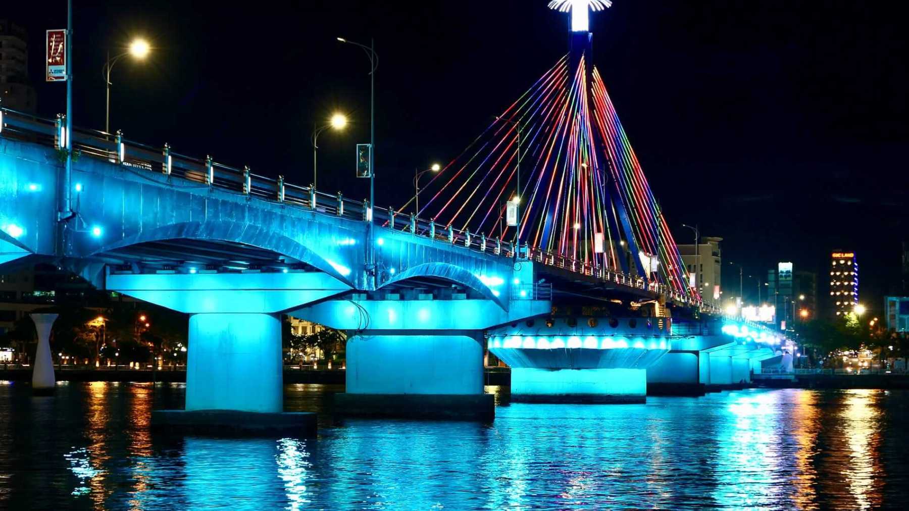 a large bridge lit up at night
