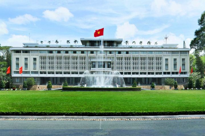 a train is parked on the side of Independence Palace