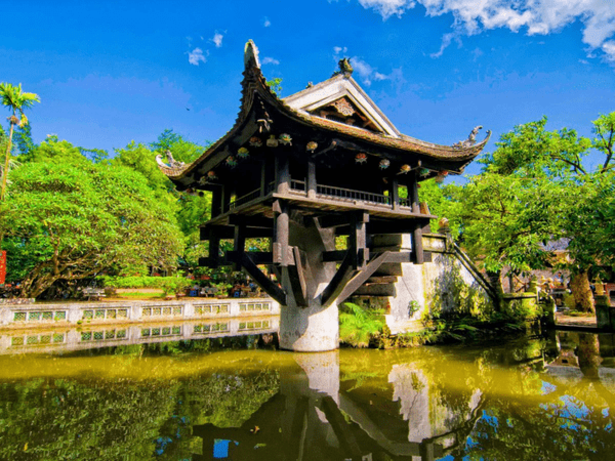 a castle with a clock at the top of a body of water
