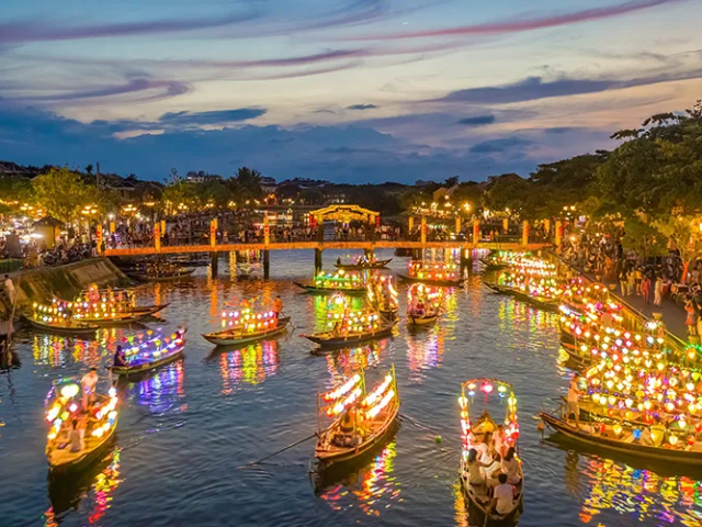 a small boat in a body of water with a city in the background