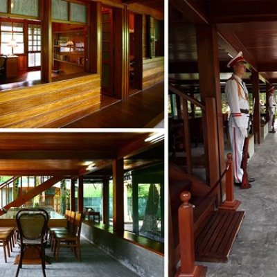 Wooden interior with chairs and table, military mannequins on exterior covered walkway.