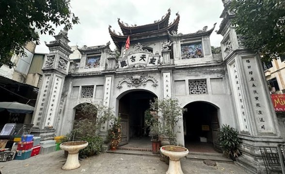 Traditional Asian temple entrance with ornate details and columns.