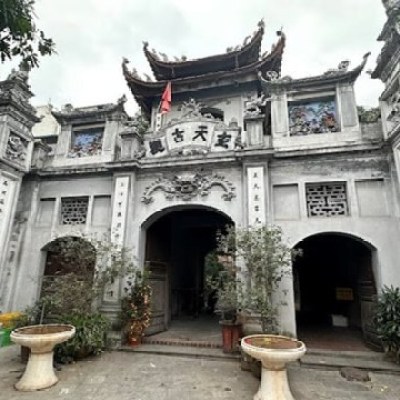 Traditional Asian temple entrance with ornate details and columns.