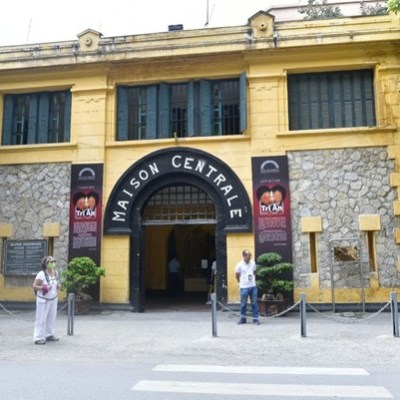 Entrance of the historic Maison Centrale prison with stone walls and an arched doorway.