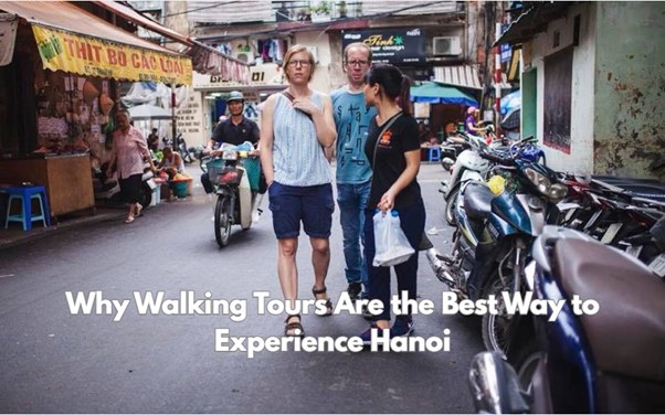 Three people walking on a narrow street in Hanoi with motorbikes and text overlay about walking tours.