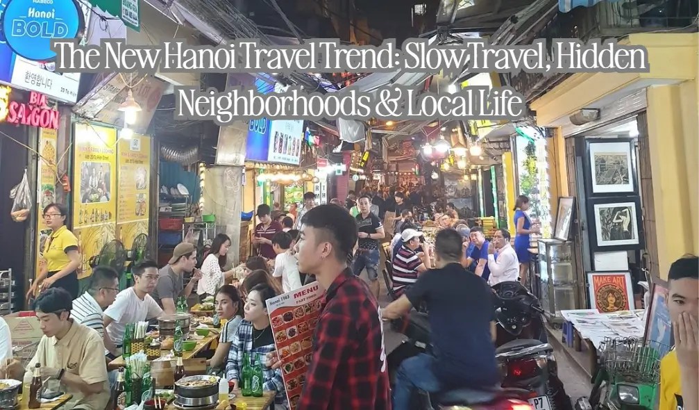 Busy Hanoi street with people dining at outdoor restaurants and a motorbike passing by.