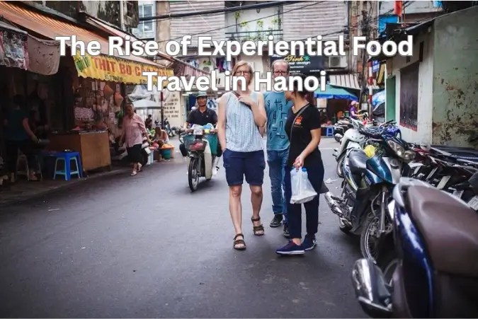 Street scene in Hanoi with people and motorbikes, featuring text about food travel.